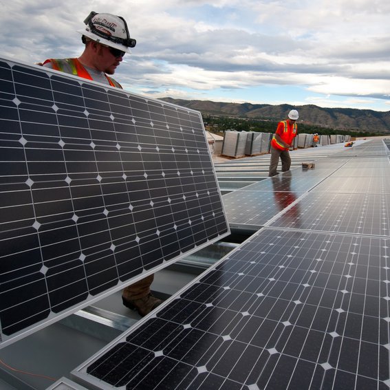 workers on solar panels
