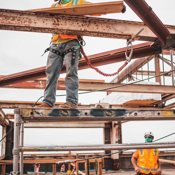 Construction worker standing on metal beams