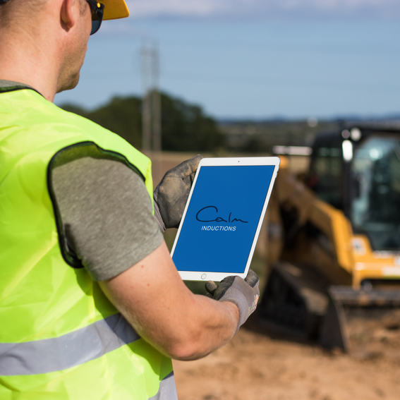 Employee holding an iPad at a construction site