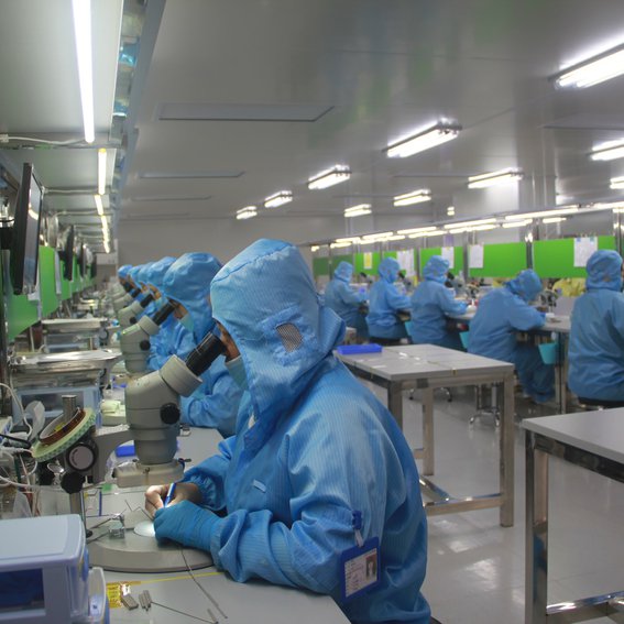 rows of medical staff in a factory